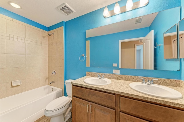 2084 La Palma Ave, Port Charlotte, FL 33953 - full bathroom with double vanity, toilet, tub / shower combination, and a textured wall