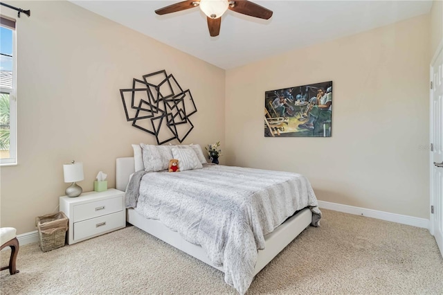 bedroom featuring a ceiling fan, baseboards, and carpet