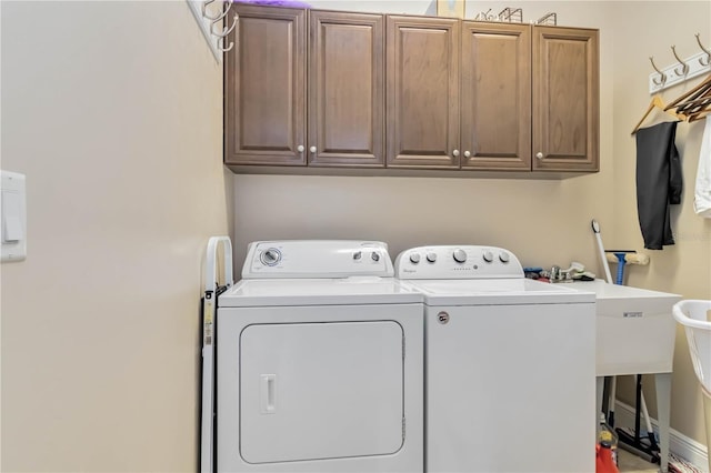 laundry room featuring a sink, cabinet space, and washer and dryer