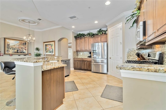 kitchen featuring crown molding, light tile patterned flooring, arched walkways, a sink, and appliances with stainless steel finishes