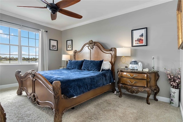 carpeted bedroom with baseboards, ornamental molding, and a ceiling fan
