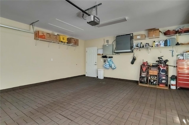 garage featuring baseboards and a garage door opener