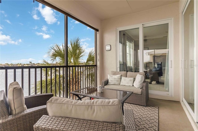 sunroom / solarium with a water view and carpet flooring