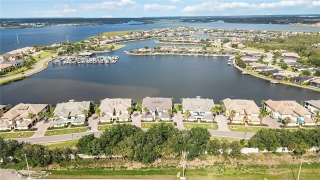 drone / aerial view featuring a water view and a residential view