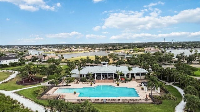 pool with a water view and a patio area