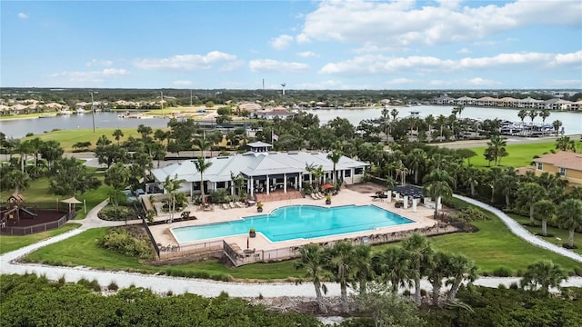 pool with a patio and a water view