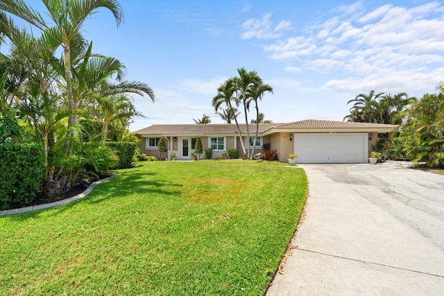 10432 Sandpiper Rd W, Bradenton, FL 34209 - ranch-style home with a garage, stucco siding, driveway, and a front yard