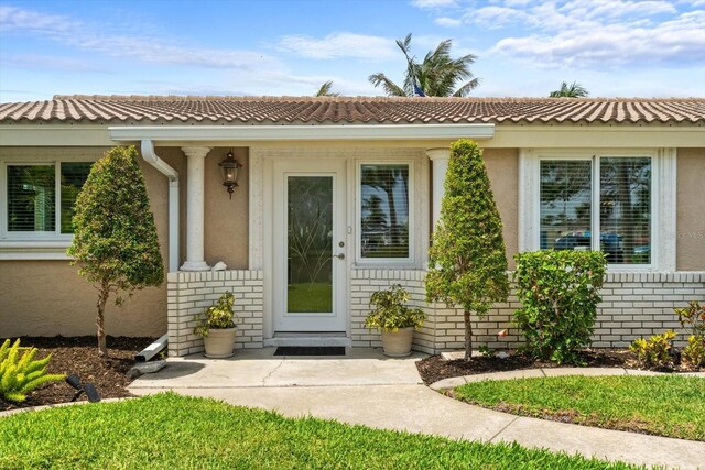 10432 Sandpiper Rd W, Bradenton, FL 34209 - doorway to property featuring stucco siding and brick siding