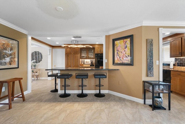 10432 Sandpiper Rd W, Bradenton, FL 34209 - kitchen with glass insert cabinets, a kitchen breakfast bar, brown cabinetry, oven, and a peninsula