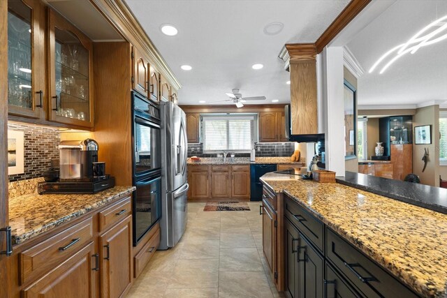 10432 Sandpiper Rd W, Bradenton, FL 34209 - kitchen featuring brown cabinets, crown molding, glass insert cabinets, black appliances, and backsplash