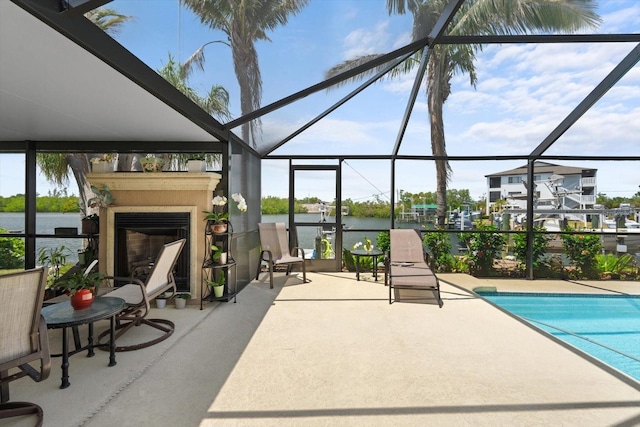10432 Sandpiper Rd W, Bradenton, FL 34209 - pool with a water view, a patio area, glass enclosure, and a fireplace