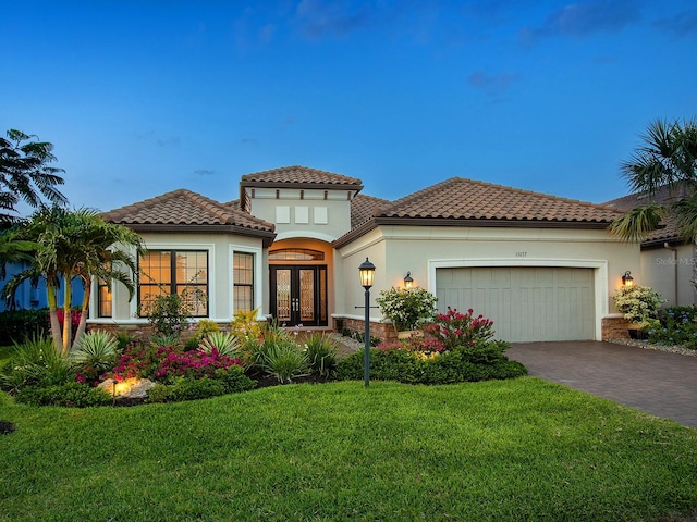 15037 Montello Way, Lakewood Ranch, FL 34211 - mediterranean / spanish-style home featuring a garage, french doors, a front lawn, and a tile roof