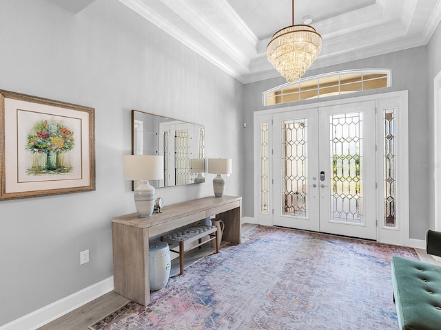 15037 Montello Way, Lakewood Ranch, FL 34211 - entrance foyer featuring ornamental molding, an inviting chandelier, french doors, and a tray ceiling