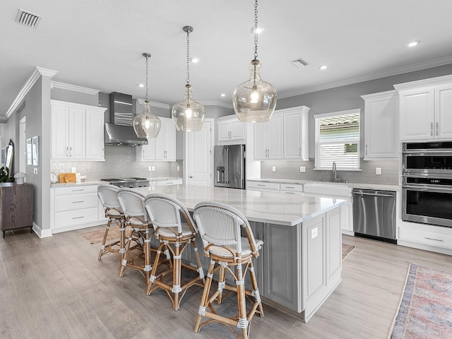 15037 Montello Way, Lakewood Ranch, FL 34211 - kitchen with wall chimney range hood, visible vents, stainless steel appliances, and crown molding