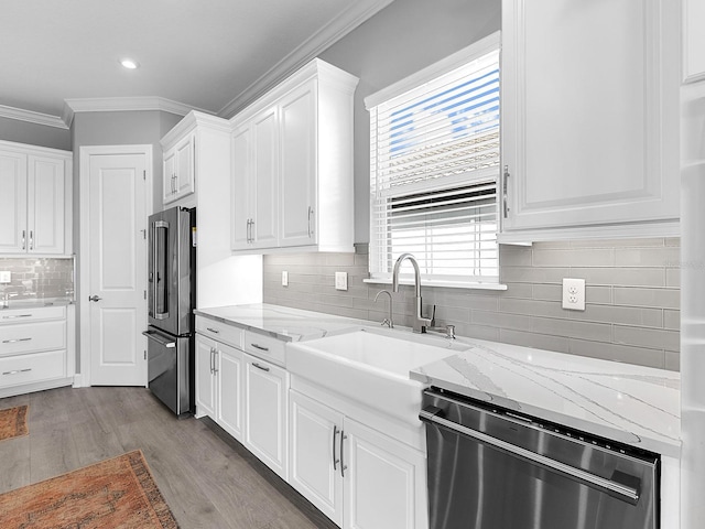 15037 Montello Way, Lakewood Ranch, FL 34211 - kitchen with white cabinetry, crown molding, dishwasher, high end refrigerator, and backsplash