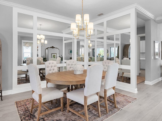 15037 Montello Way, Lakewood Ranch, FL 34211 - dining room with visible vents, a notable chandelier, light wood finished floors, and crown molding