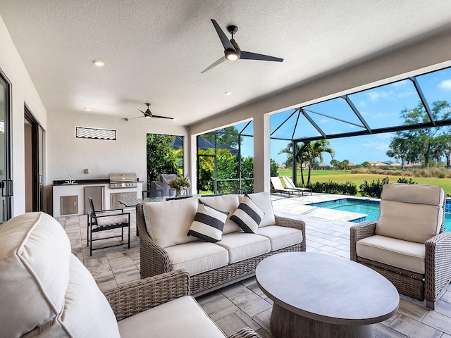 15037 Montello Way, Lakewood Ranch, FL 34211 - view of patio / terrace with an outdoor hangout area, an outdoor pool, exterior kitchen, a ceiling fan, and a grill