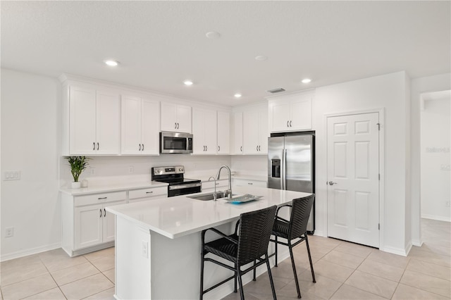 9725 Last Light Gln, Parrish, FL 34219 - kitchen featuring appliances with stainless steel finishes, light tile patterned floors, baseboards, light countertops, and recessed lighting