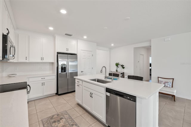 9725 Last Light Gln, Parrish, FL 34219 - kitchen featuring stainless steel appliances, a sink, light tile patterned flooring, white cabinetry, and light countertops
