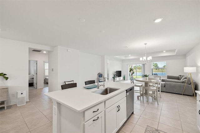 9725 Last Light Gln, Parrish, FL 34219 - kitchen featuring open floor plan, stainless steel dishwasher, a sink, light tile patterned floors, and a raised ceiling
