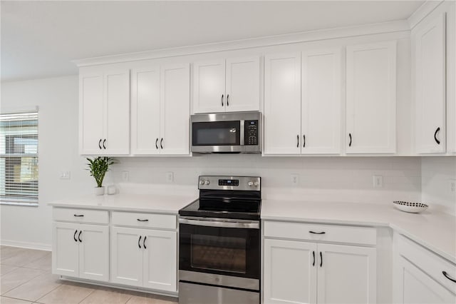 9725 Last Light Gln, Parrish, FL 34219 - kitchen featuring appliances with stainless steel finishes, decorative backsplash, light countertops, white cabinetry, and light tile patterned floors