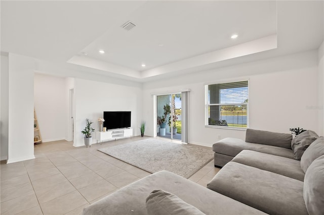 9725 Last Light Gln, Parrish, FL 34219 - living area featuring light tile patterned floors, a raised ceiling, recessed lighting, and baseboards