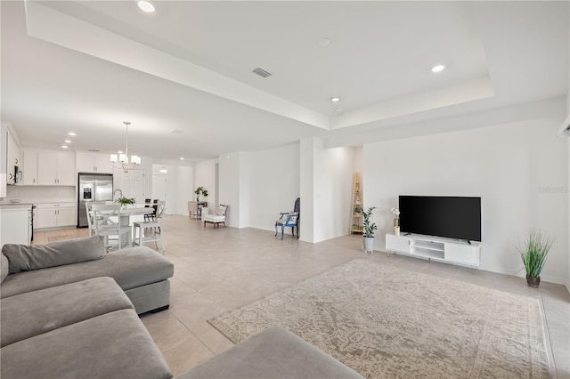 9725 Last Light Gln, Parrish, FL 34219 - living area with recessed lighting, a chandelier, light tile patterned flooring, and a raised ceiling