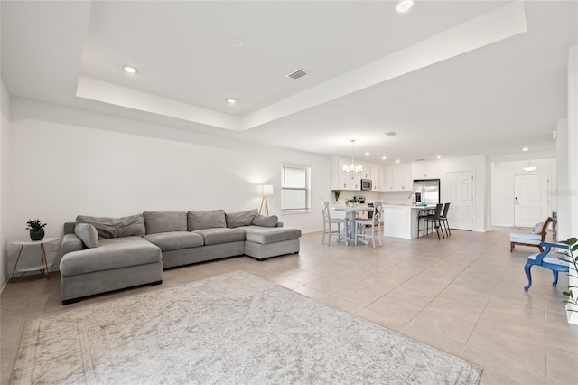 9725 Last Light Gln, Parrish, FL 34219 - living room with light tile patterned flooring, recessed lighting, a chandelier, a raised ceiling, and baseboards