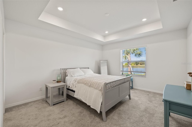 9725 Last Light Gln, Parrish, FL 34219 - bedroom with light carpet, a raised ceiling, recessed lighting, and baseboards