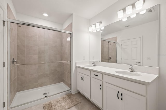 9725 Last Light Gln, Parrish, FL 34219 - bathroom featuring tile patterned floors, a stall shower, double vanity, and recessed lighting