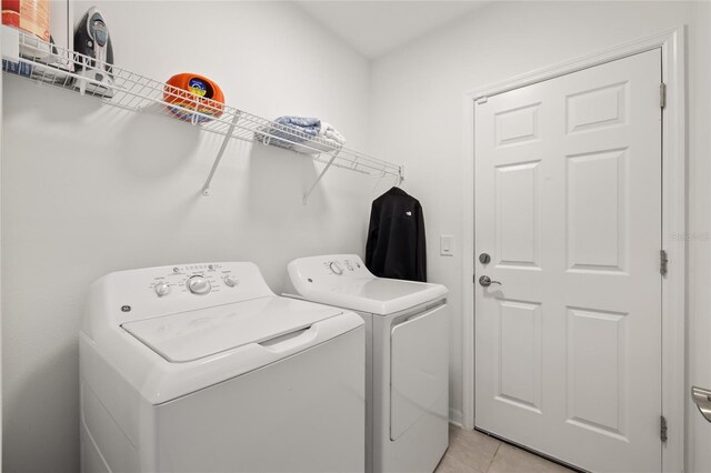 9725 Last Light Gln, Parrish, FL 34219 - washroom featuring independent washer and dryer and light tile patterned floors