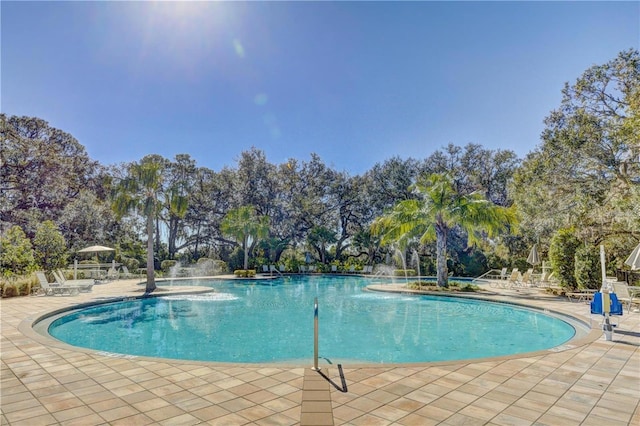 9725 Last Light Gln, Parrish, FL 34219 - community pool featuring a patio and view of wooded area