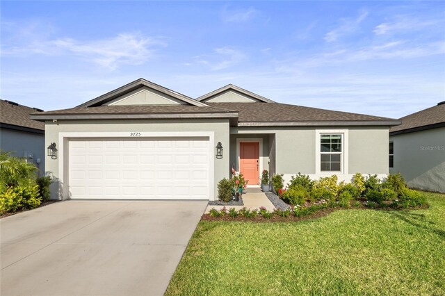 9725 Last Light Gln, Parrish, FL 34219 - single story home featuring concrete driveway, a front lawn, a shingled roof, an attached garage, and stucco siding
