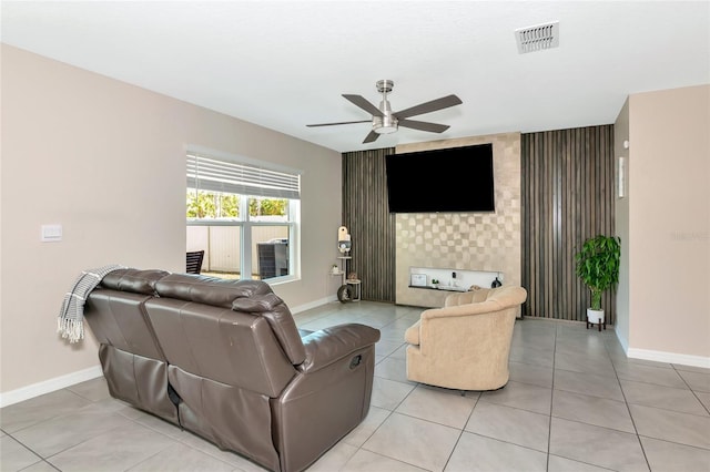 2969 Great Abaco Way, Bradenton, FL 34208 - living area featuring an accent wall, ceiling fan, baseboards, and light tile patterned flooring