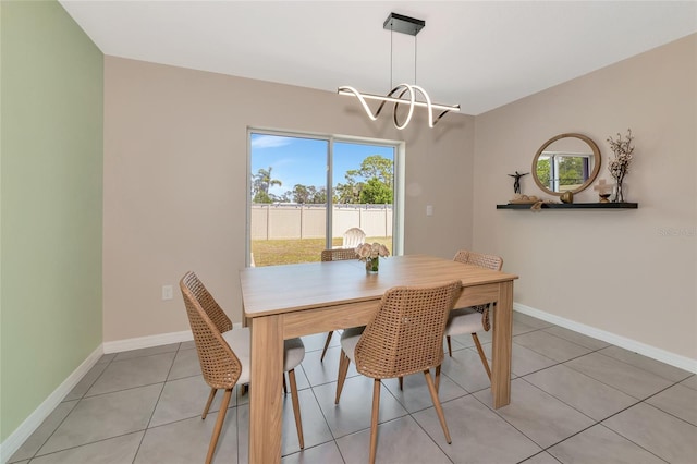 2969 Great Abaco Way, Bradenton, FL 34208 - dining area with a chandelier, tile patterned flooring, and baseboards