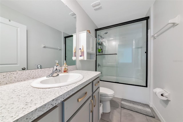 2969 Great Abaco Way, Bradenton, FL 34208 - bathroom with toilet, tile patterned flooring, vanity, and shower / bath combination with glass door