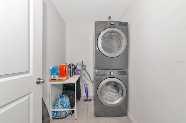2969 Great Abaco Way, Bradenton, FL 34208 - clothes washing area with stacked washer / drying machine, tile patterned flooring, and baseboards