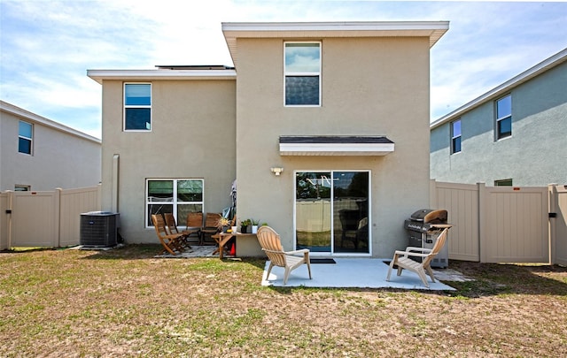 2969 Great Abaco Way, Bradenton, FL 34208 - back of house featuring stucco siding, cooling unit, a patio, and a gate