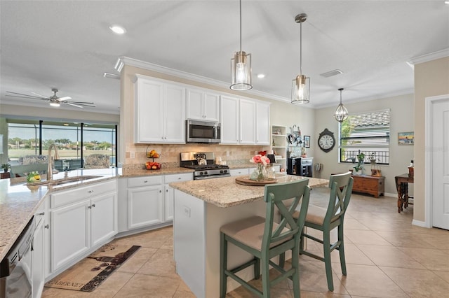14309 Carolina Sky Pl, Lakewood Ranch, FL 34211 - kitchen with light tile patterned flooring, plenty of natural light, appliances with stainless steel finishes, and a sink