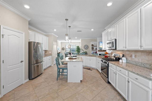 14309 Carolina Sky Pl, Lakewood Ranch, FL 34211 - kitchen featuring stainless steel appliances, decorative backsplash, a peninsula, ornamental molding, and white cabinets