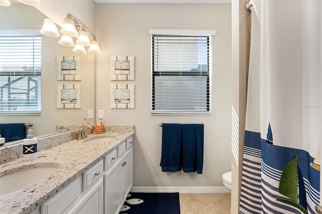 14309 Carolina Sky Pl, Lakewood Ranch, FL 34211 - bathroom with double vanity, baseboards, tile patterned flooring, and a sink