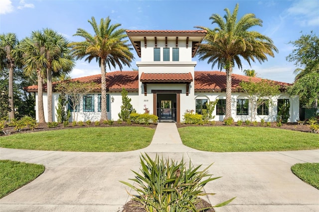 14309 Carolina Sky Pl, Lakewood Ranch, FL 34211 - mediterranean / spanish-style home with stucco siding, a tiled roof, and a front lawn