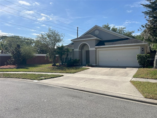ranch-style house with stucco siding, fence, concrete driveway, and a garage
