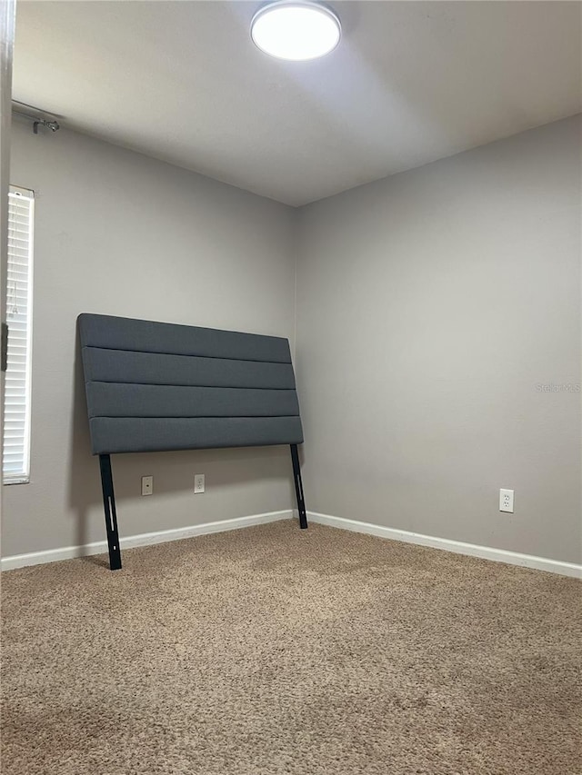 unfurnished bedroom featuring baseboards and carpet flooring