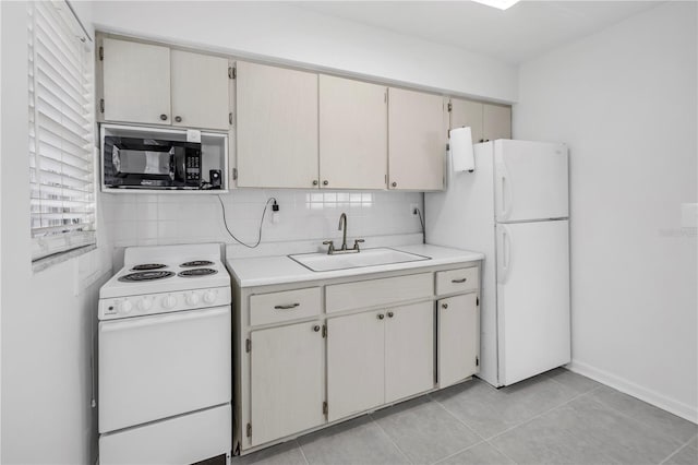 kitchen featuring tasteful backsplash, a sink, white appliances, light tile patterned floors, and light countertops