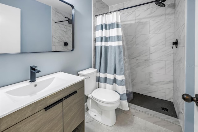 full bathroom with toilet, vanity, and tiled shower