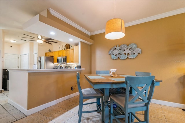 dining room featuring light tile patterned floors, baseboards, and ornamental molding