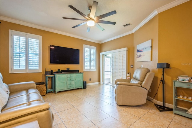 living area with ceiling fan, visible vents, baseboards, ornamental molding, and light tile patterned flooring
