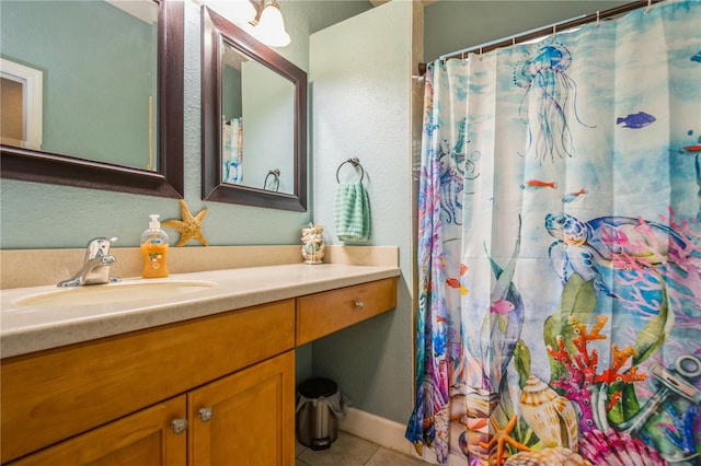 bathroom featuring a shower with curtain, tile patterned floors, and vanity