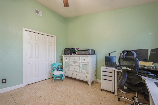 office space with light tile patterned floors, baseboards, ceiling fan, and visible vents